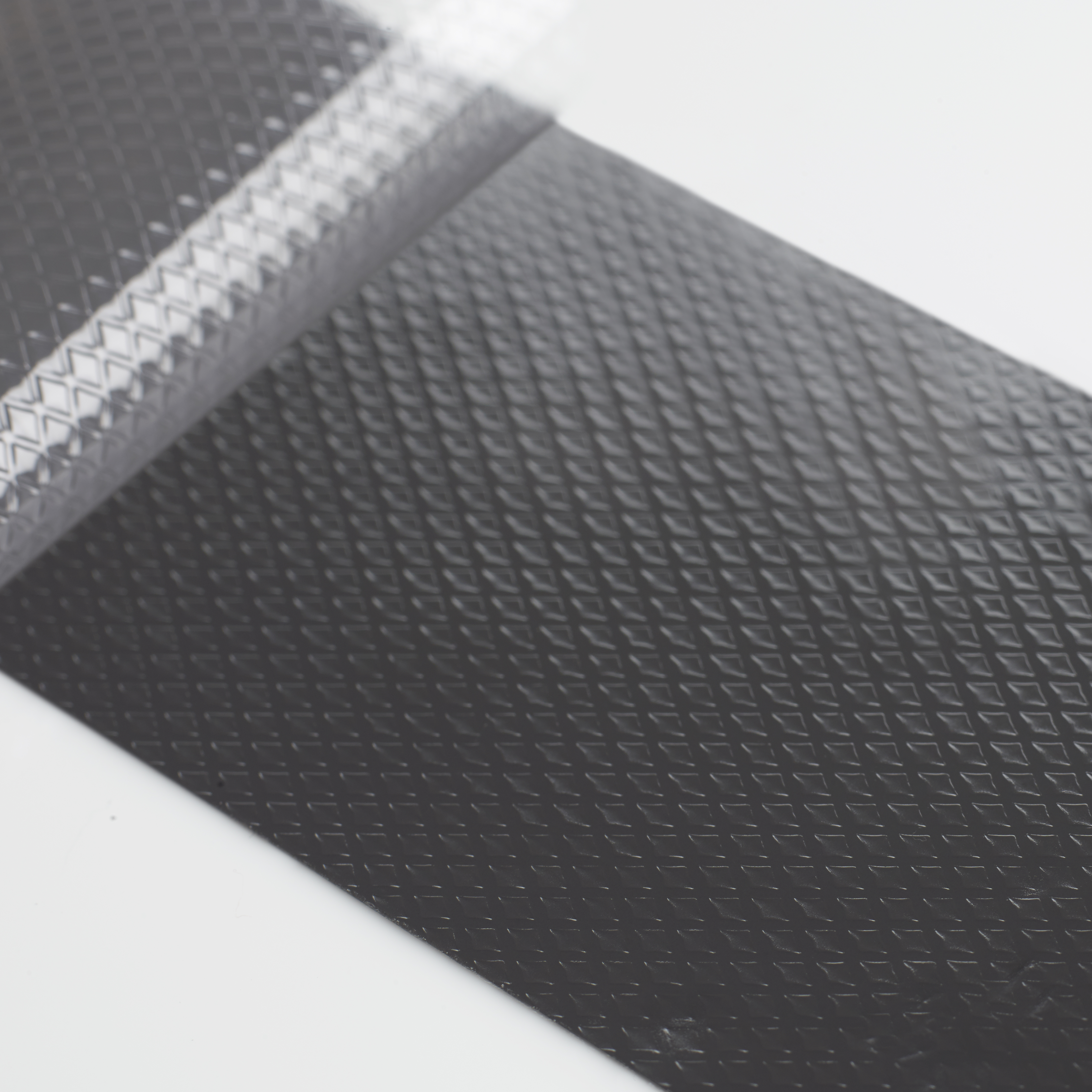 Tecman72204 TIM Black Textured With Liner Peeling Off Macro Shot